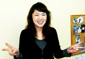 笑顔でピースサインをしている、当店のスタイリスト北添美智子さんの写真